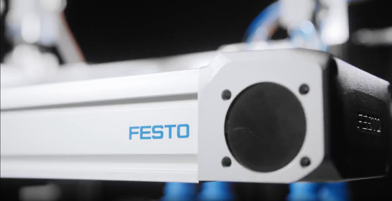 Festo robot arm with 'Festo' branding on a blurred background